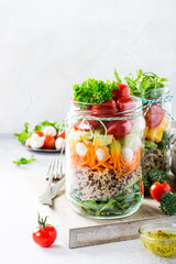 Homemade salad in glass jar with quinoa and vegetables. Healthy food, diet, detox, clean eating and vegetarian concept with copy space.