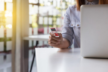 woman holding credit card with laptop computer for online shopping