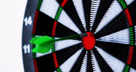 Video footage of three green darts hit bullseye. Professional shot in 4K resolution