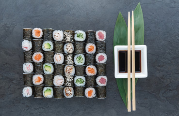 Sushi net on a black surface. Flat lay