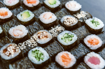 Sushi net on a black surface. Flat lay