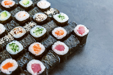 Sushi net on a black surface. Flat lay
