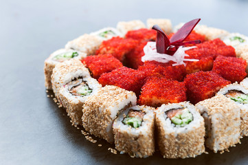 Sushi net on a black surface. Flat lay