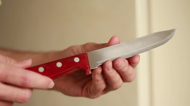 Kitchen knife in man's hands