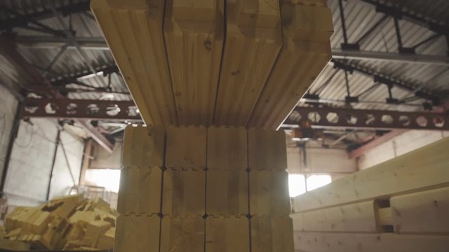 Ready glulam folded neatly in a pile. Manufacture of wood glued beams. LVL Laminated Veneer Lumbe. Engineered stress-rated product created by bonding together individual pieces of lumber.