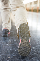 Young man run on the station platform with backpack on train station