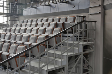 Rows of gray soft seats in empty cinema hall