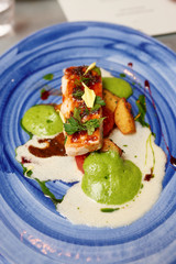 Chicken fillet on blue porcelain plate
