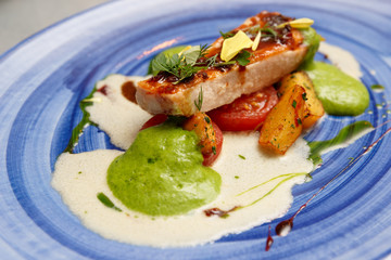 Chicken fillet on blue porcelain plate