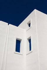 Whitewashed Greek house with blue shutters