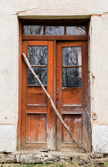 old broken door of an abandoned house