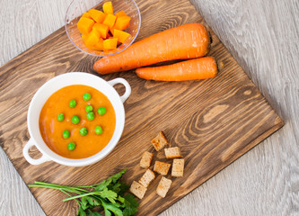 Cream-soup from vegetables, pumpkins and carrots on a wooden table. Dietary and vegetarian food. Healthy lifestyle.