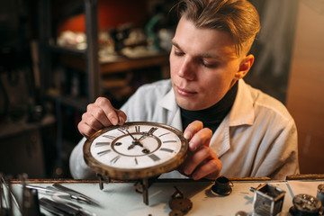 Watchmaker adjusts the mechanism of old watches