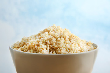 Ceramic bowl with boiled sprouted organic white quinoa grains, closeup