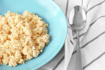 Blue plate with healthy quinoa porridge on table