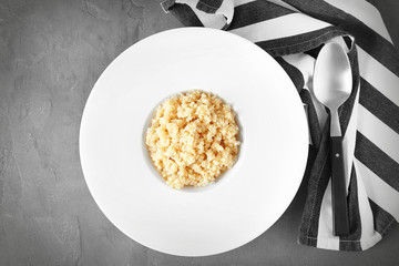 White plate with healthy quinoa porridge on table