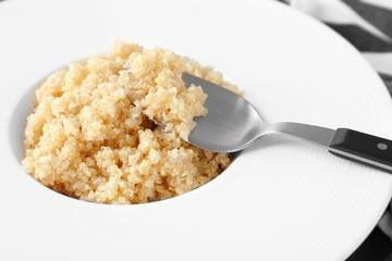 White plate with healthy quinoa porridge, closeup