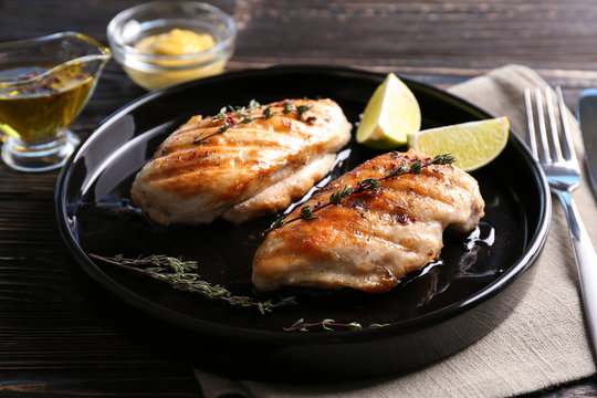 Delicious chicken breasts with lime on plate