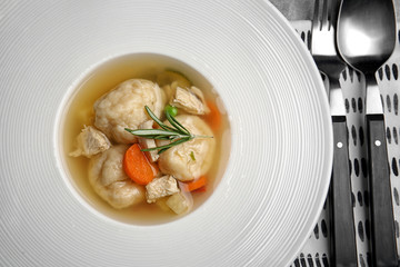 Portion of delicious chicken and dumplings in modern white plate