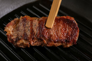 Cooking concept. Preparation of delicious steak on grill pan