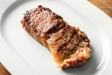 Plate with tasty steak, closeup