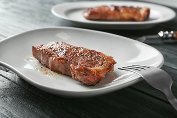 Plate with tasty steak, closeup