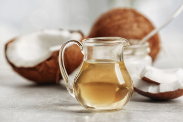 Fresh coconut oil in glassware on grey table