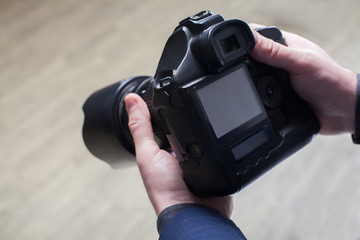 Male photographer hands holding digital camera