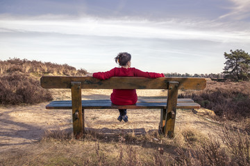 Woman sitting on a bench in nature