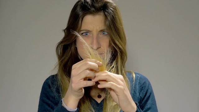 Woman angry about split ends hair medium shot