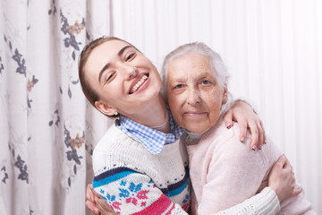 Care is at home of elderly. Space for text. Senior woman with their caregiver at home. Concept of health care for elderly old people, disabled. Elderly woman.