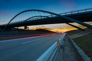 Fototapeta na wymiar modern bridge ovet the highway, evening light,Nitra, Slovakia