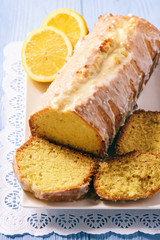 Homemade lemon bread on wooden background.