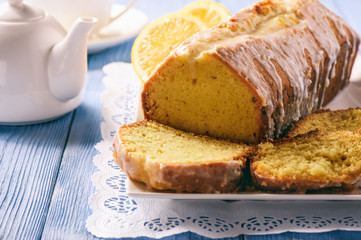Homemade lemon bread on wooden background.