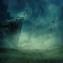 Young boy jumping from the edge of a cliff, falling down while his wings grow and help to fly....