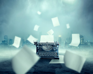 Vintage typewriter, urban landscape on background