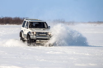 Fototapeta na wymiar Classic SUV riding in the snow