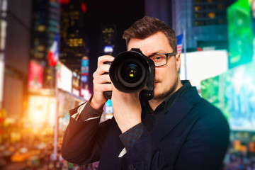 Male photographer in glasses with digital camera