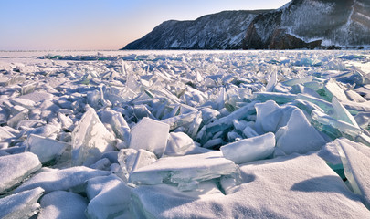 Fototapeta na wymiar A large section of hummocks on ice of frozen lake Baikal