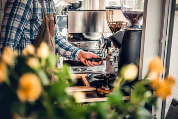 A man preparing cappuccino in a coffee machine.