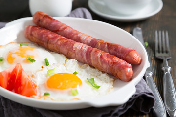 Fried eggs with sausages, breakfast