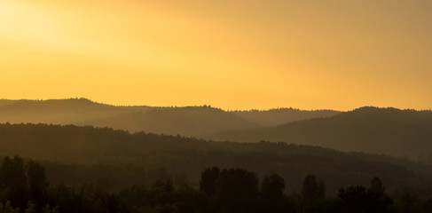 Morning forest and mountains on the horizon