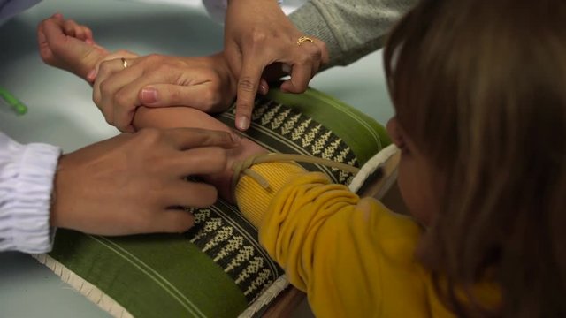 5-year-old Girl Having A Blood Test, Nurse Is Drawing Blood Sample In Medical Surgery From A Vein In The Arm