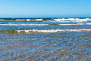 Ocean with waves and blue sky above