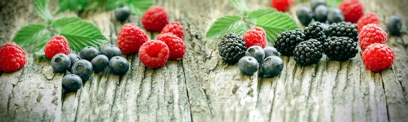 Zelfklevend Fotobehang Healthy berry fruit on rustic table - healthy diet with forest fruits, berries © PhotoIris2021