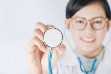 portrait of Asia women  doctor on plain background.Focus on Stethoscope Classic Cardiology