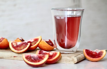 glass of fresh orange  with slices of red oranges 