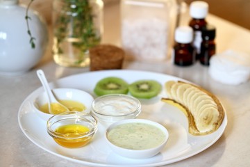 a homemade facial mask with kiwi and banana on a white  plate