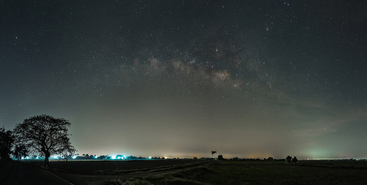 Milky way galaxy with stars and space dust in terraced rice field. (Visible noise due to high ISO, soft focus, shallow DOF, slight motion blur)