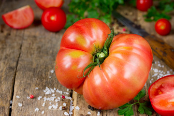 Fresh ripe big red tomato on wood background